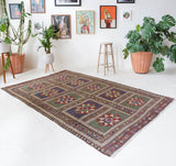 Vintage kilim rug in living room setting, old rug, antique rug, pastel colors, faded colors, Turkish rug, vintage rug, soft rug, Portland, Oregon, rug store, rug shop, local shop, earthy tones, earthy colors, warm colors