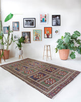 Vintage kilim rug in living room setting, old rug, antique rug, pastel colors, faded colors, Turkish rug, vintage rug, soft rug, Portland, Oregon, rug store, rug shop, local shop, earthy tones, earthy colors, warm colors