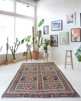 Vintage kilim rug in living room setting, old rug, antique rug, pastel colors, faded colors, Turkish rug, vintage rug, soft rug, Portland, Oregon, rug store, rug shop, local shop, earthy tones, earthy colors, warm colors
