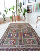 Vintage kilim rug in living room setting, old rug, antique rug, pastel colors, faded colors, Turkish rug, vintage rug, soft rug, Portland, Oregon, rug store, rug shop, local shop, earthy tones, earthy colors, warm colors