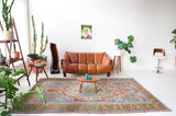 Vintage Turkish rug in living room setting, old rug, antique rug, pastel colors, faded colors, Turkish rug, vintage rug, soft rug, Portland, Oregon, rug store, rug shop, local shop