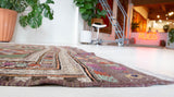 Vintage kilim rug in living room setting, old rug, antique rug, pastel colors, faded colors, Turkish rug, vintage rug, soft rug, Portland, Oregon, rug store, rug shop, local shop, earthy tones, earthy colors, warm colors