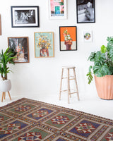 Vintage kilim rug in living room setting, old rug, antique rug, pastel colors, faded colors, Turkish rug, vintage rug, soft rug, Portland, Oregon, rug store, rug shop, local shop, earthy tones, earthy colors, warm colors