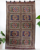 Vintage kilim rug in living room setting, old rug, antique rug, pastel colors, faded colors, Turkish rug, vintage rug, soft rug, Portland, Oregon, rug store, rug shop, local shop, earthy tones, earthy colors, warm colors