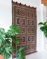 Vintage kilim rug in living room setting, old rug, antique rug, pastel colors, faded colors, Turkish rug, vintage rug, soft rug, Portland, Oregon, rug store, rug shop, local shop, earthy tones, earthy colors, warm colors