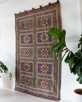 Vintage kilim rug in living room setting, old rug, antique rug, pastel colors, faded colors, Turkish rug, vintage rug, soft rug, Portland, Oregon, rug store, rug shop, local shop, earthy tones, earthy colors, warm colors