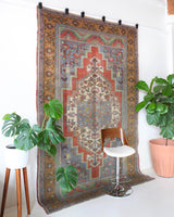 Vintage Turkish rug in living room setting, old rug, antique rug, pastel colors, faded colors, Turkish rug, vintage rug, soft rug, Portland, Oregon, rug store, rug shop, local shop
