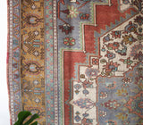 Vintage Turkish rug in living room setting, old rug, antique rug, pastel colors, faded colors, Turkish rug, vintage rug, soft rug, Portland, Oregon, rug store, rug shop, local shop