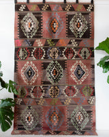 Vintage kilim rug in living room setting, old rug, antique rug, pastel colors, faded colors, Turkish rug, vintage rug, soft rug, Portland, Oregon, rug store, rug shop, local shop, earthy tones, earthy colors, warm colors