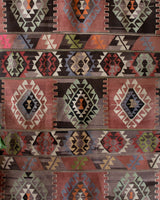 Vintage kilim rug in living room setting, old rug, antique rug, pastel colors, faded colors, Turkish rug, vintage rug, soft rug, Portland, Oregon, rug store, rug shop, local shop, earthy tones, earthy colors, warm colors