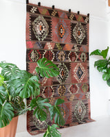 Vintage kilim rug in living room setting, old rug, antique rug, pastel colors, faded colors, Turkish rug, vintage rug, soft rug, Portland, Oregon, rug store, rug shop, local shop, earthy tones, earthy colors, warm colors