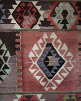Vintage kilim rug in living room setting, old rug, antique rug, pastel colors, faded colors, Turkish rug, vintage rug, soft rug, Portland, Oregon, rug store, rug shop, local shop, earthy tones, earthy colors, warm colors
