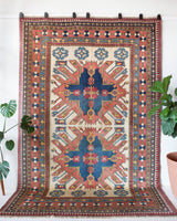 Vintage Turkish rug in living room setting, old rug, antique rug, pastel colors, faded colors, Turkish rug, vintage rug, soft rug, Portland, Oregon, rug store, rug shop, local shop