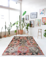 Vintage kilim rug in living room setting, old rug, antique rug, pastel colors, faded colors, Turkish rug, vintage rug, soft rug, Portland, Oregon, rug store, rug shop, local shop, earthy tones, earthy colors, warm colors