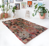 Vintage kilim rug in living room setting, old rug, antique rug, pastel colors, faded colors, Turkish rug, vintage rug, soft rug, Portland, Oregon, rug store, rug shop, local shop, earthy tones, earthy colors, warm colors