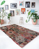 Vintage kilim rug in living room setting, old rug, antique rug, pastel colors, faded colors, Turkish rug, vintage rug, soft rug, Portland, Oregon, rug store, rug shop, local shop, earthy tones, earthy colors, warm colors