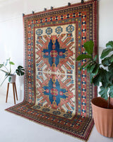 Vintage Turkish rug in living room setting, old rug, antique rug, pastel colors, faded colors, Turkish rug, vintage rug, soft rug, Portland, Oregon, rug store, rug shop, local shop