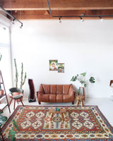 Vintage Turkish rug in a living room setting, pile rug, Turkish rug, vintage rug, portland, rug shop, bright colors, wild shaman, soft rug, bold color, Portland, Oregon, rug store, rug shop, local shop