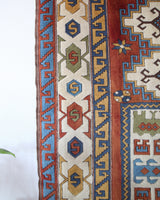 Vintage Turkish rug in a living room setting, pile rug, Turkish rug, vintage rug, portland, rug shop, bright colors, wild shaman, soft rug, bold color, Portland, Oregon, rug store, rug shop, local shop