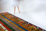 Vintage Turkish runner rug in a living room setting, pile rug, Turkish rug, vintage rug, portland, rug shop, bright colors, wild shaman, soft rug, bold color, Portland, Oregon, rug store, rug shop, local shop, antique rug
