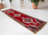 Vintage Turkish runner rug in a living room setting, pile rug, Turkish rug, vintage rug, portland, rug shop, bright colors, wild shaman, soft rug, bold color, Portland, Oregon, rug store, rug shop, local shop, antique rug
