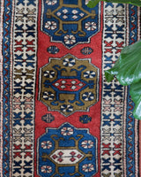 Vintage Turkish runner rug in living room setting, old rug, antique rug, pastel colors, faded colors, Turkish rug, vintage rug, soft rug, Portland, Oregon, rug store, rug shop, local shop