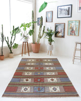 Vintage kilim rug in living room setting, old rug, antique rug, pastel colors, faded colors, Turkish rug, vintage rug, soft rug, Portland, Oregon, rug store, rug shop, local shop, earthy tones, earthy colors, warm colors