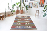 Vintage kilim rug in living room setting, old rug, antique rug, pastel colors, faded colors, Turkish rug, vintage rug, soft rug, Portland, Oregon, rug store, rug shop, local shop, earthy tones, earthy colors, warm colors