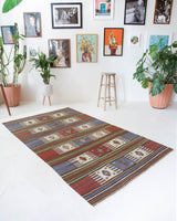 Vintage kilim rug in living room setting, old rug, antique rug, pastel colors, faded colors, Turkish rug, vintage rug, soft rug, Portland, Oregon, rug store, rug shop, local shop, earthy tones, earthy colors, warm colors