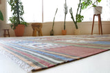 Vintage kilim rug in living room setting, old rug, antique rug, pastel colors, faded colors, Turkish rug, vintage rug, soft rug, Portland, Oregon, rug store, rug shop, local shop, earthy tones, earthy colors, warm colors