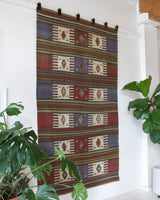 Vintage kilim rug in living room setting, old rug, antique rug, pastel colors, faded colors, Turkish rug, vintage rug, soft rug, Portland, Oregon, rug store, rug shop, local shop, earthy tones, earthy colors, warm colors