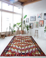 Vintage kilim rug in room decor setting, old rug, antique rug, pastel colors, faded colors, Turkish rug, vintage rug, soft rug, Portland, Oregon, rug store, rug shop, local shop, bold colors, bright colors, faded colors