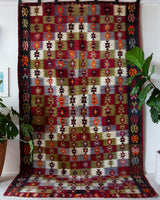 Vintage kilim rug in room decor setting, old rug, antique rug, pastel colors, faded colors, Turkish rug, vintage rug, soft rug, Portland, Oregon, rug store, rug shop, local shop, bold colors, bright colors, faded colors