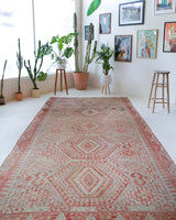 Vintage kilim rug in living room setting, old rug, antique rug, pastel colors, faded colors, Turkish rug, vintage rug, soft rug, Portland, Oregon, rug store, rug shop, local shop, earthy tones, earthy colors, warm colors