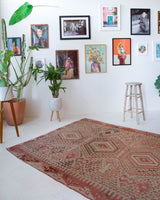 Vintage kilim rug in living room setting, old rug, antique rug, pastel colors, faded colors, Turkish rug, vintage rug, soft rug, Portland, Oregon, rug store, rug shop, local shop, earthy tones, earthy colors, warm colors