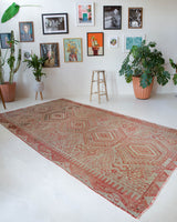 Vintage kilim rug in living room setting, old rug, antique rug, pastel colors, faded colors, Turkish rug, vintage rug, soft rug, Portland, Oregon, rug store, rug shop, local shop, earthy tones, earthy colors, warm colors