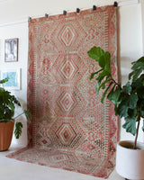 Vintage kilim rug in living room setting, old rug, antique rug, pastel colors, faded colors, Turkish rug, vintage rug, soft rug, Portland, Oregon, rug store, rug shop, local shop, earthy tones, earthy colors, warm colors