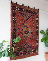 Vintage Turkish rug in a living room setting, pile rug, Turkish rug, vintage rug, portland, rug shop, bright colors, wild shaman, soft rug, bold color, Portland, Oregon, rug store, rug shop, local shop, antique rug