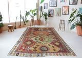Vintage kilim rug in room decor setting, old rug, antique rug, pastel colors, faded colors, Turkish rug, vintage rug, soft rug, Portland, Oregon, rug store, rug shop, local shop, bold colors, bright colors, faded colors