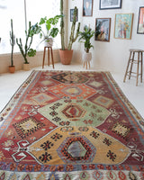 Vintage kilim rug in room decor setting, old rug, antique rug, pastel colors, faded colors, Turkish rug, vintage rug, soft rug, Portland, Oregon, rug store, rug shop, local shop, bold colors, bright colors, faded colors