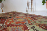 Vintage kilim rug in room decor setting, old rug, antique rug, pastel colors, faded colors, Turkish rug, vintage rug, soft rug, Portland, Oregon, rug store, rug shop, local shop, bold colors, bright colors, faded colors
