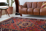 Vintage Turkish rug in a living room setting, pile rug, Turkish rug, vintage rug, portland, rug shop, bright colors, wild shaman, soft rug, bold color, Portland, Oregon, rug store, rug shop, local shop, antique rug