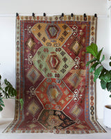 Vintage kilim rug in room decor setting, old rug, antique rug, pastel colors, faded colors, Turkish rug, vintage rug, soft rug, Portland, Oregon, rug store, rug shop, local shop, bold colors, bright colors, faded colors