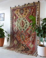 Vintage kilim rug in room decor setting, old rug, antique rug, pastel colors, faded colors, Turkish rug, vintage rug, soft rug, Portland, Oregon, rug store, rug shop, local shop, bold colors, bright colors, faded colors