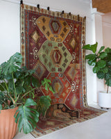 Vintage kilim rug in room decor setting, old rug, antique rug, pastel colors, faded colors, Turkish rug, vintage rug, soft rug, Portland, Oregon, rug store, rug shop, local shop, bold colors, bright colors, faded colors