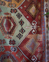 Vintage kilim rug in room decor setting, old rug, antique rug, pastel colors, faded colors, Turkish rug, vintage rug, soft rug, Portland, Oregon, rug store, rug shop, local shop, bold colors, bright colors, faded colors