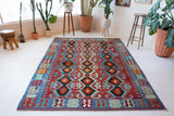 Vintage kilim rug in living room setting, bright colors, wild shaman, soft rug, bold color, Portland, Oregon, rug store, rug shop, local shop, vintage rug, modern kilim, warm colors