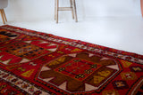 Vintage Turkish runner rug in a living room setting, pile rug, Turkish rug, vintage rug, portland, rug shop, bright colors, wild shaman, soft rug, bold color, Portland, Oregon, rug store, rug shop, local shop, antique rug