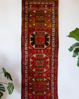 Vintage Turkish runner rug in a living room setting, pile rug, Turkish rug, vintage rug, portland, rug shop, bright colors, wild shaman, soft rug, bold color, Portland, Oregon, rug store, rug shop, local shop, antique rug