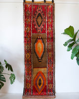 Vintage Turkish runner rug in a living room setting, pile rug, Turkish rug, vintage rug, portland, rug shop, bright colors, wild shaman, soft rug, bold color, Portland, Oregon, rug store, rug shop, local shop, antique rug